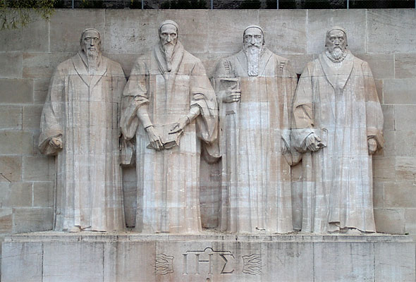 The Reformation Wall in Geneva, Switzerland, commemorating key figures of the Protestant Reformation. William Farel, John Calvin, Theodore Beza, and John Knox are depicted here.